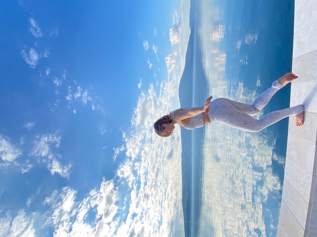 woman walking infront of a blue lake